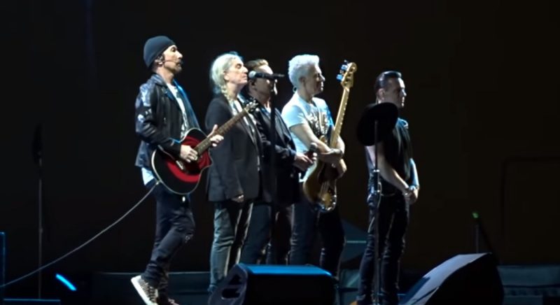 U2 spotted paying tribute to kiwi roadie Greg Carroll at Auckland's One Tree Hill